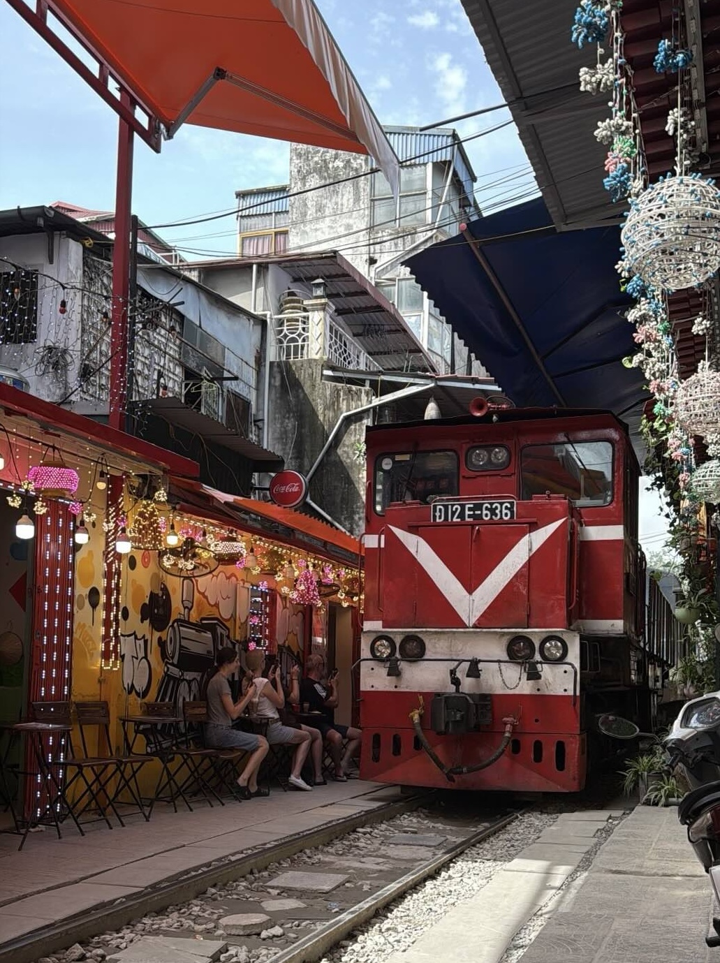 Train street in Hanoi with tracks passing close to buildings